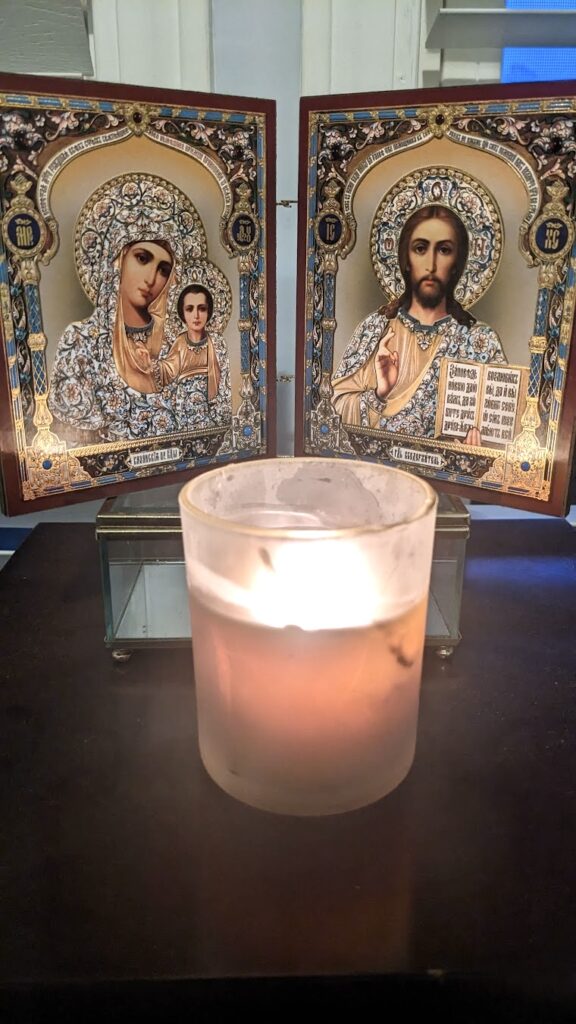 dyptyph of The Mother of God and Jesus Christ with a candle in front of it