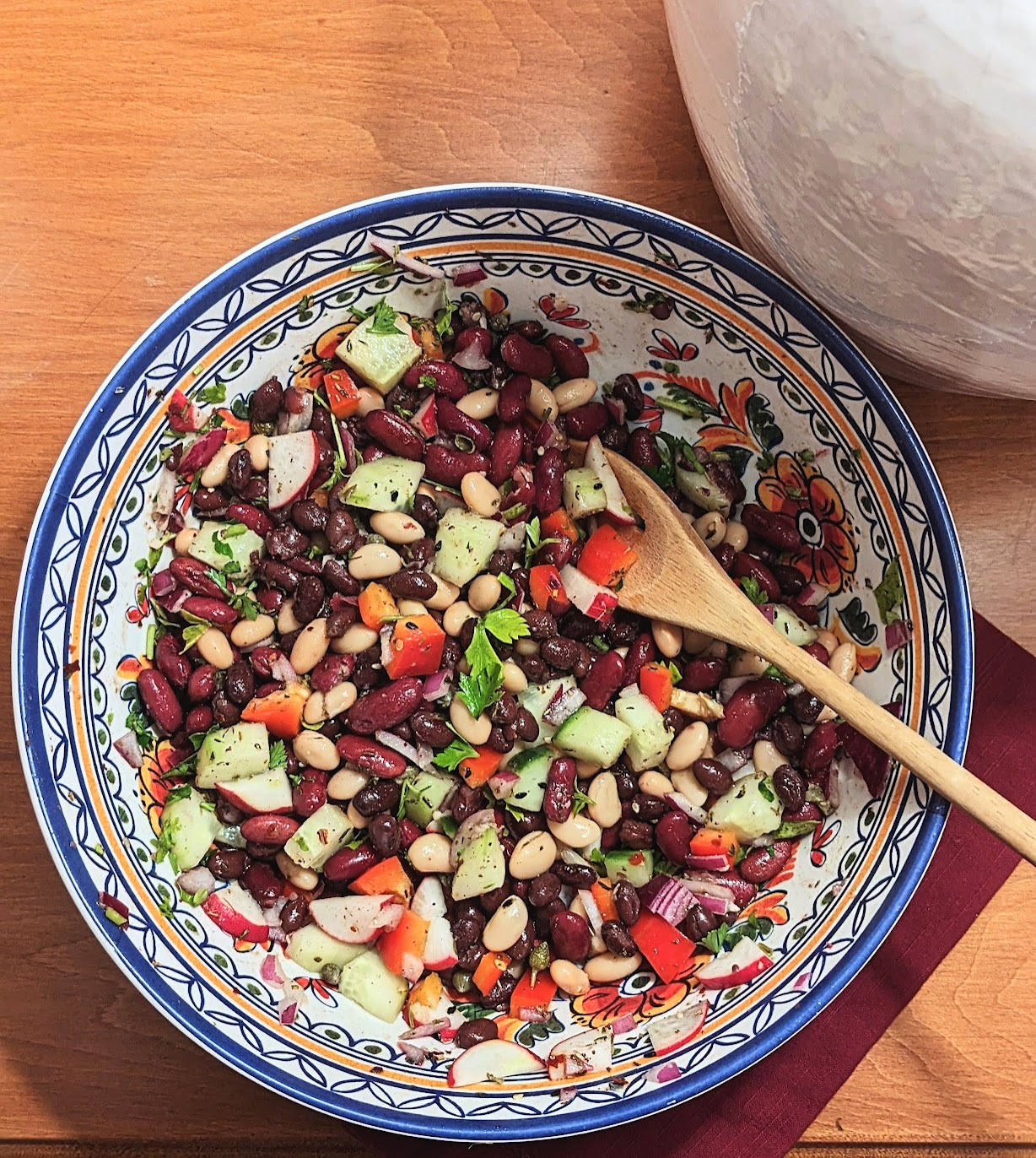 bean salad in beautiful mediterranean bowl with a spoon