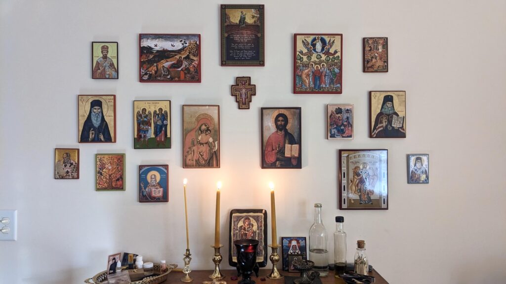 straight forward view of icons in the prayer corner with candles lit