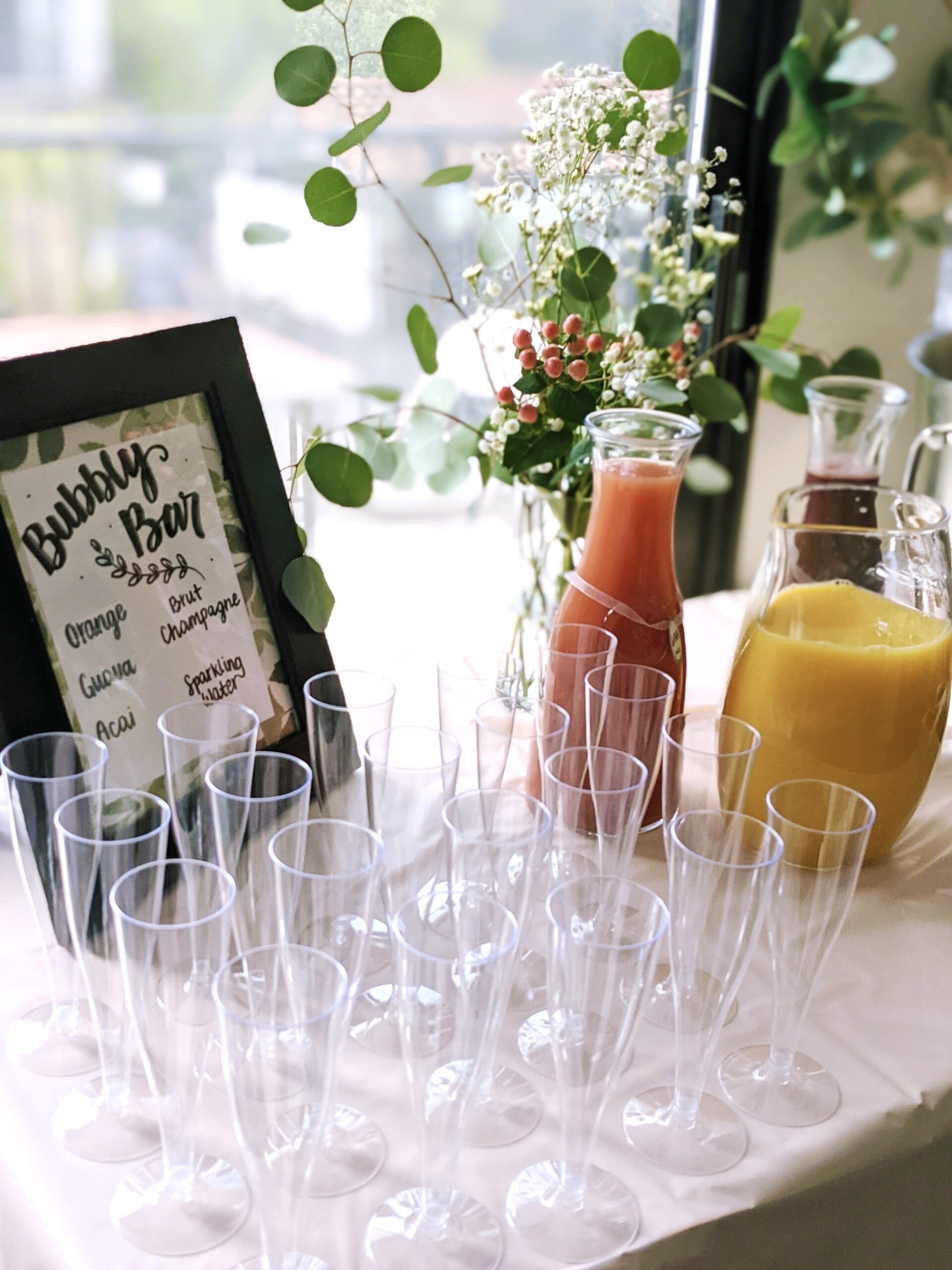 drink station with fresh juices and empty glasses