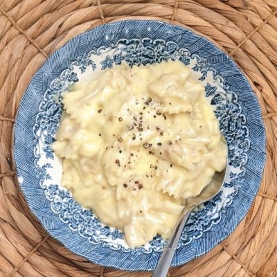 top view of a bowl of homemade macaroni and cheese with a spoon