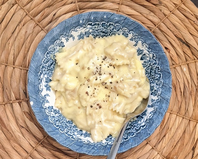 top view of a bowl of homemade macaroni and cheese with a spoon