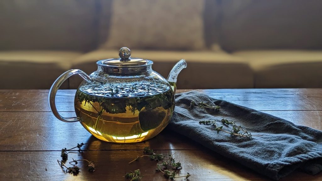 pretty thyme blossoms in a glass tea pot