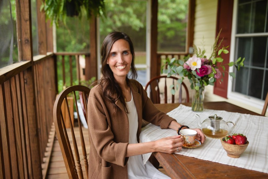 woman sitting at table drinking tea