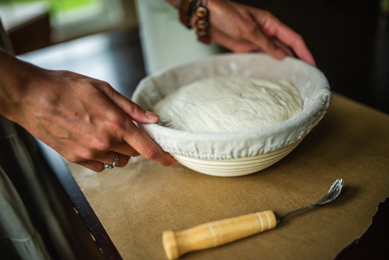 banneton basket with sourdough and bread knife