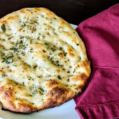 zoomed out angle of sourdough focaccia bread on a plate