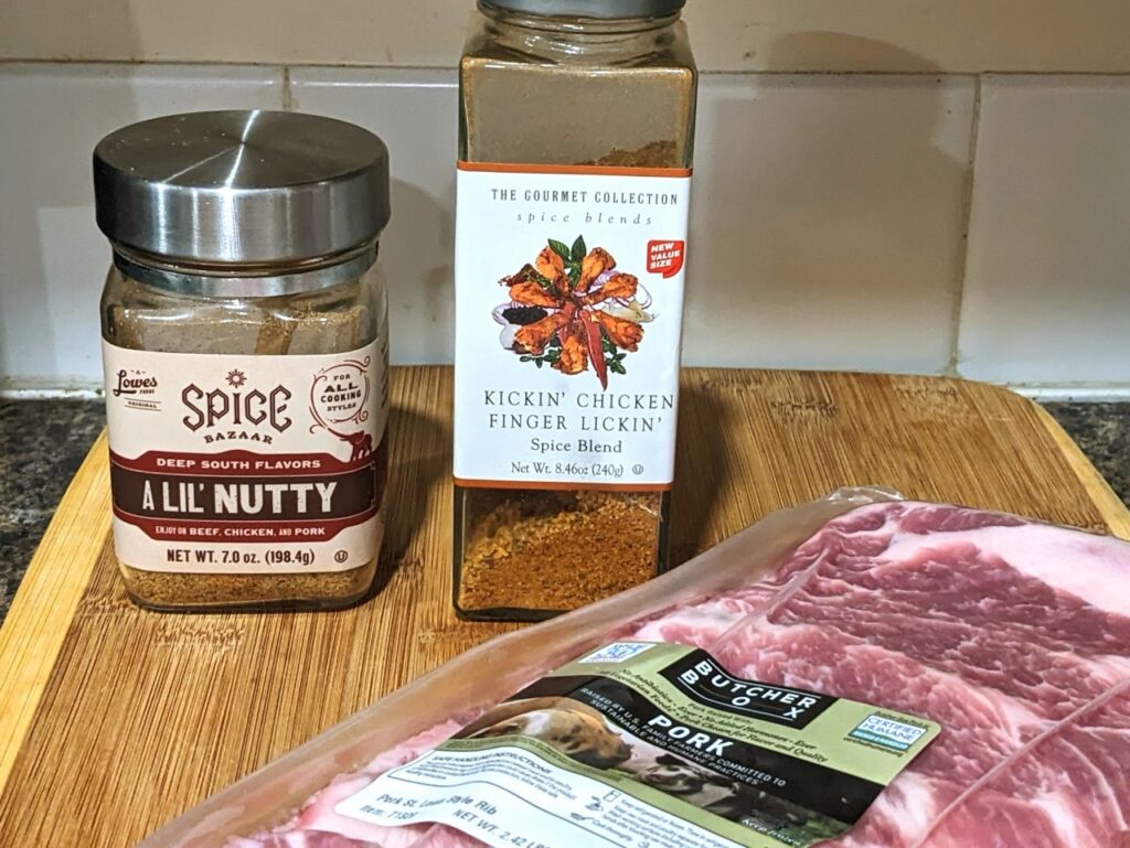 spice blends on a cutting board with packaged ribs